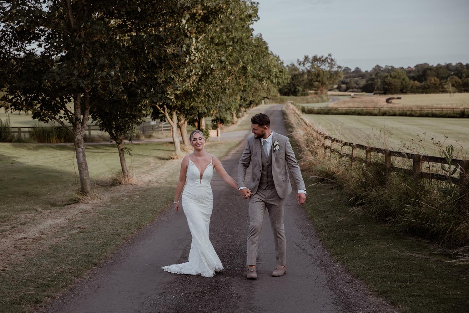 Bride and groom walking in hand at Crockwell Farm wedding